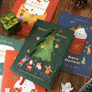 Vintage 3D hollow Christmas greeting cards with envelopes on a festive wood background