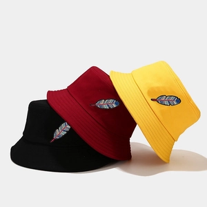 Cotton bucket hats with colorful feather embroidery in black, burgundy and yellow