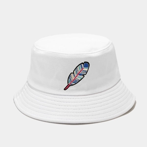 Close-up of colorful feather embroidery detail on a white cotton bucket hat for summer