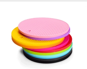 Detailed stack of colorful round honeycomb silicone mats with hanging holes