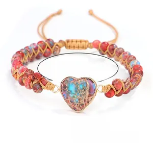 Detailed close-up of heart-shaped imperial stone on a double-layer woven beaded bracelet