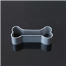 Macro detail of a grey bone-shaped cookie cutter mold with smooth edges
