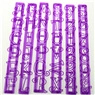 Detailed view of 6 purple plastic strip molds with cutout letters and numbers for baking