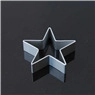 Detailed view of a star-shaped silver metal cookie cutter on a black reflective surface