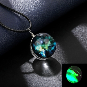 Detailed view of the galaxy glass ball necklace with a glowing green nebula pendant