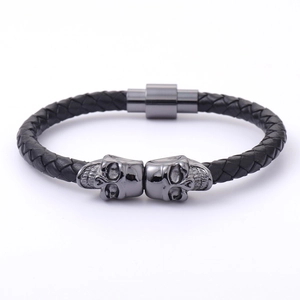 Men's punk braided leather bracelet featuring dual metal skull charms and magnetic clasp