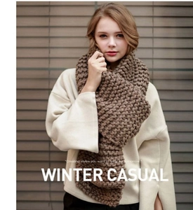 Detail showing thick chunky knit texture of dark brown winter scarf for women