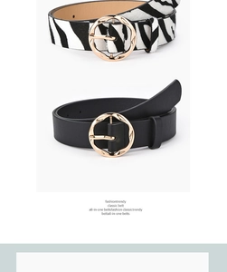Close-up of zebra pattern faux fur and black leather belts with gold wavy buckles