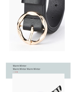 Close-up of black leather belt featuring a designer golden wavy irregular round metal buckle