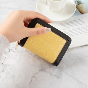 Slim yellow crocodile pattern card holder wallet with black trim and gold zipper detail