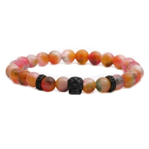 Handmade 8mm natural agate bead bracelet featuring a black skull accent on white background