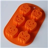 Macro detail of an orange silicone mold with six unique Halloween pumpkin cavity designs