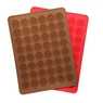Detail of red and brown silicone baking molds with circular cavities for DIY treats