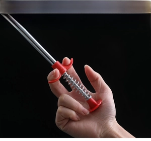 Operating the flexible stainless steel drain clog remover tool for hair removal
