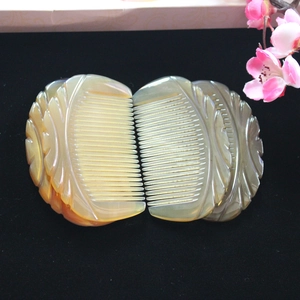 Macro detail of hand-carved natural yak horn combs with translucent yellow texture