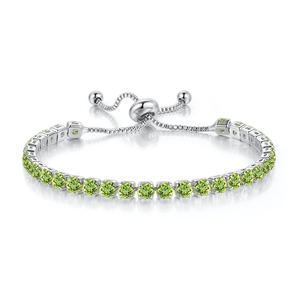 Detail of adjustable silver tennis bracelet with round olive green stones and bolo clasp