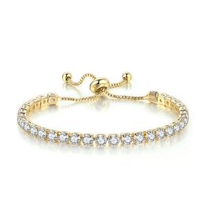 Detail view of gold tennis bracelet featuring round zircons and adjustable sliding clasp