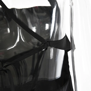 Detailed close-up of the elegant black satin top featuring adjustable criss-cross back ties