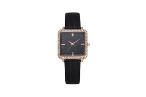Close-up of square starry dial watch with rose gold rhinestone bezel and woven strap