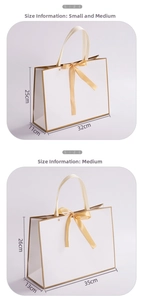 Detailed view of white gift bags with gold trim and bow, showing size 32x11x25cm and 35x13x26cm