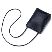 Detail of the black textured leather neck pouch showing the snap button and slim lanyard