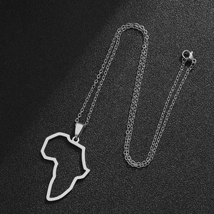 Detailed close-up of a silver stainless steel Africa map pendant necklace on dark leather