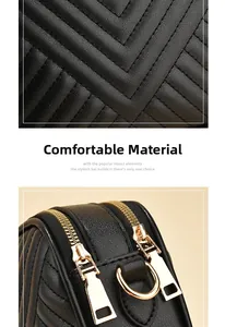 Macro detail of black quilted faux leather fabric and golden metal hardware on a crossbody bag