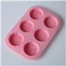 Pink silicone mold with 6 semi-sphere cavities and floral patterns for cake baking