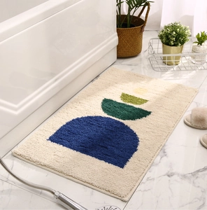 Detail of modern beige plush bathroom mat with geometric patterns on marble floor