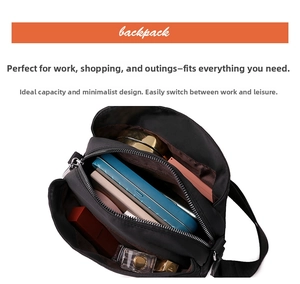 Detail view of the black multi-pocket crossbody bag interior with large storage capacity
