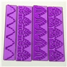 Detail of four purple floral silicone fondant molds with embossed lace patterns for baking