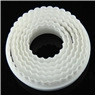 Detailed view of white bone-shaped plastic cookie cutter showing curved ribbed texture