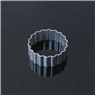 Macro detail of round scalloped edge stainless steel cookie cutter on dark background