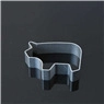 Detailed view of pig shaped stainless steel cookie cutter on a reflective surface