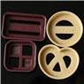 Detail of 3D heart and flower baking cutters in purple and beige plastic material
