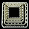 Detailed view of four nested white plastic square cookie cutters with scalloped edges