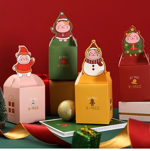 Detail of colorful Christmas apple gift boxes with festive cartoon character handles