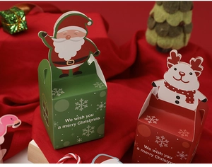 Detailed close-up of festive Christmas apple gift boxes featuring Santa and Reindeer designs