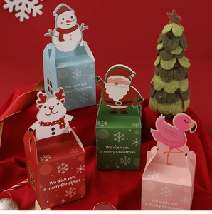 Detailed view of Christmas apple gift boxes featuring Santa, snowman, and reindeer patterns