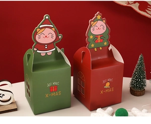 Detail of red and green Christmas gift boxes with festive cat inserts and handles