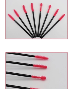 Macro detail of disposable pink silicone eyelash brushes with spiral bristles and black handles