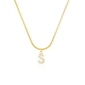 Macro shot of gold snake chain with a crystal-studded letter S pendant and soft reflection