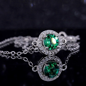 925 silver emerald bracelet with sparkling pavé diamonds on a black reflective background