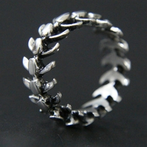 Macro shot of antique silver fish bone ring showing detailed spinal segment design