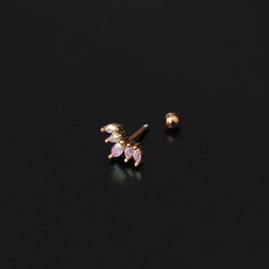 Macro detail of a gold crown tragus stud featuring iridescent marquise-cut marquise stones