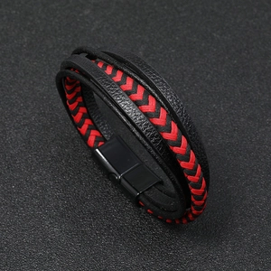 Close-up of multilayered black and red braided leather bracelet with magnetic metal clasp