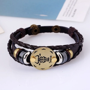 Detail of Taurus zodiac multi-layer woven leather bracelet with antique bronze metal charms