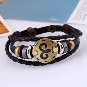 Close-up of Aries zodiac bronze charm on multi-layer braided dark brown leather bracelet