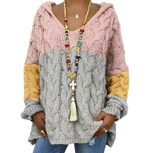 Detail of color-block knit hoodie with pink, grey and yellow cable stitch texture