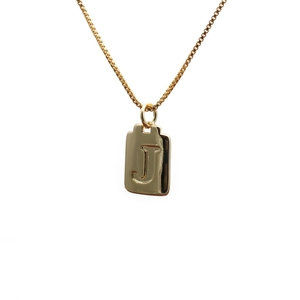 Polished gold copper pendant necklace featuring an engraved letter J on a white background